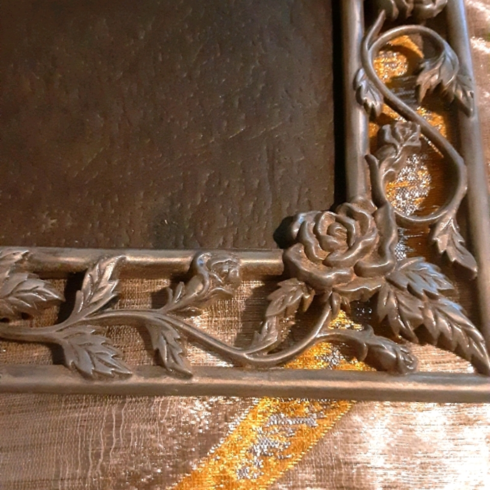 2 metal picture frames attached